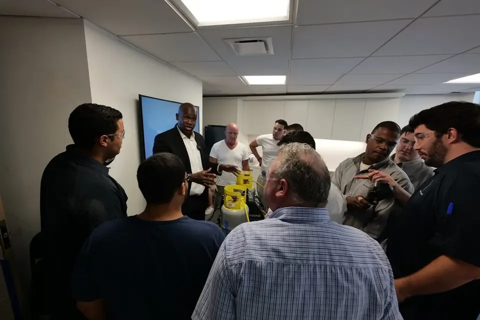 A Tauris Tech instructor demonstrating equipment to a group of students